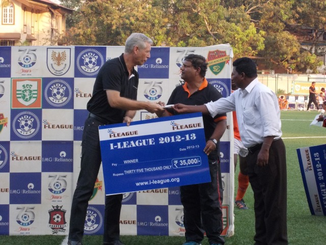 Sporting Goa Manager, Anju Albuerquerque receiving the winners cheque from India coach Wim Koervermans